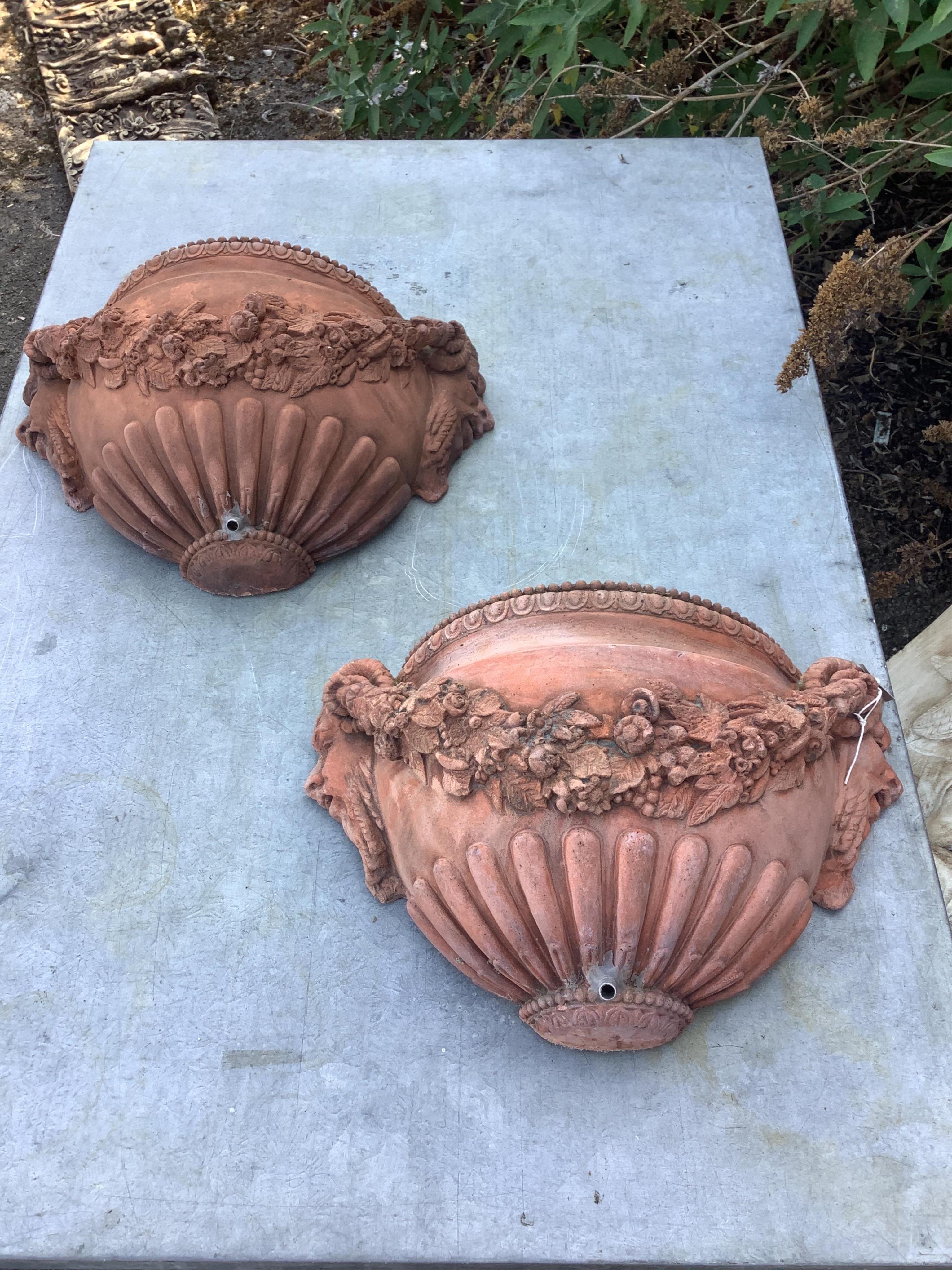 A pair of terracotta wall pocket garden fountains, width 46cm, depth 16cm, height 27cm